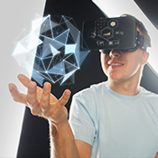 Teen uses virtual reality headset holding floating geometric image