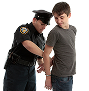 Police Officer handcuffing teen