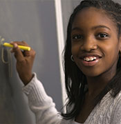 Girl doing math at board