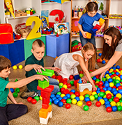 Group of K kids playing with balls and blocks