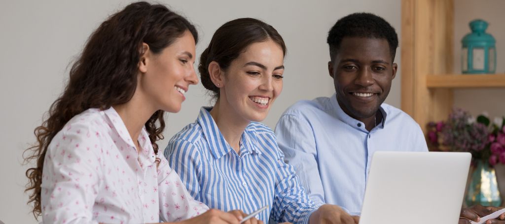 Three diverse people at a laptop