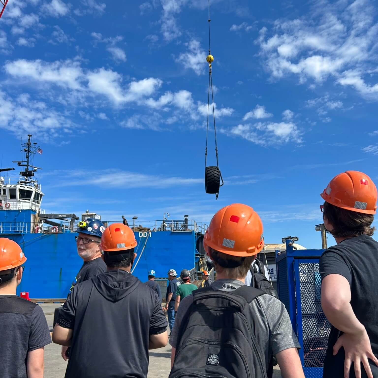 students in orange hard hats tour at Dakota Creek Industries