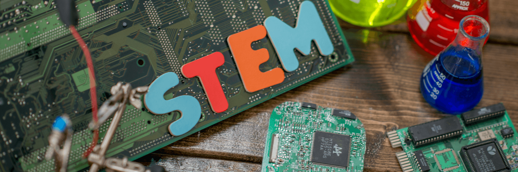 A collection of computer parts with letter spelling out STEM on top of them