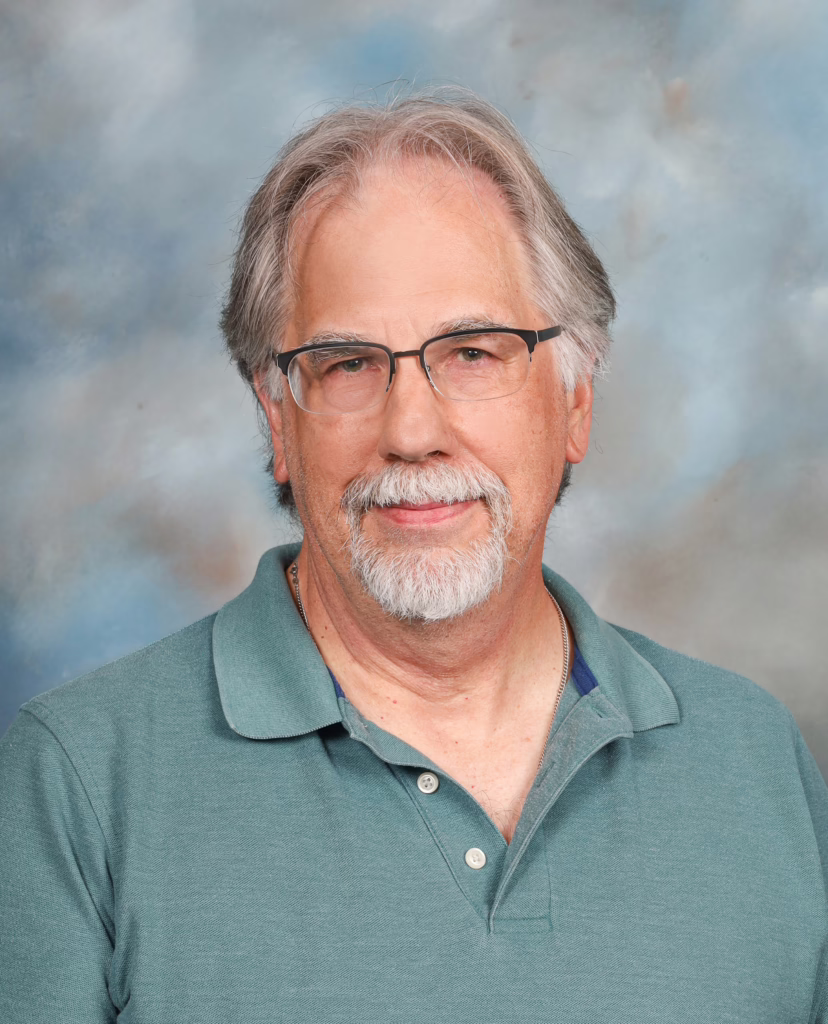 A man in a green polo and glasses